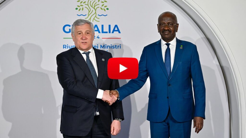 Mohamed Salem Merzoug, representative of the African Union, shakes hands to minister of foreign affairs Antonio Tajani